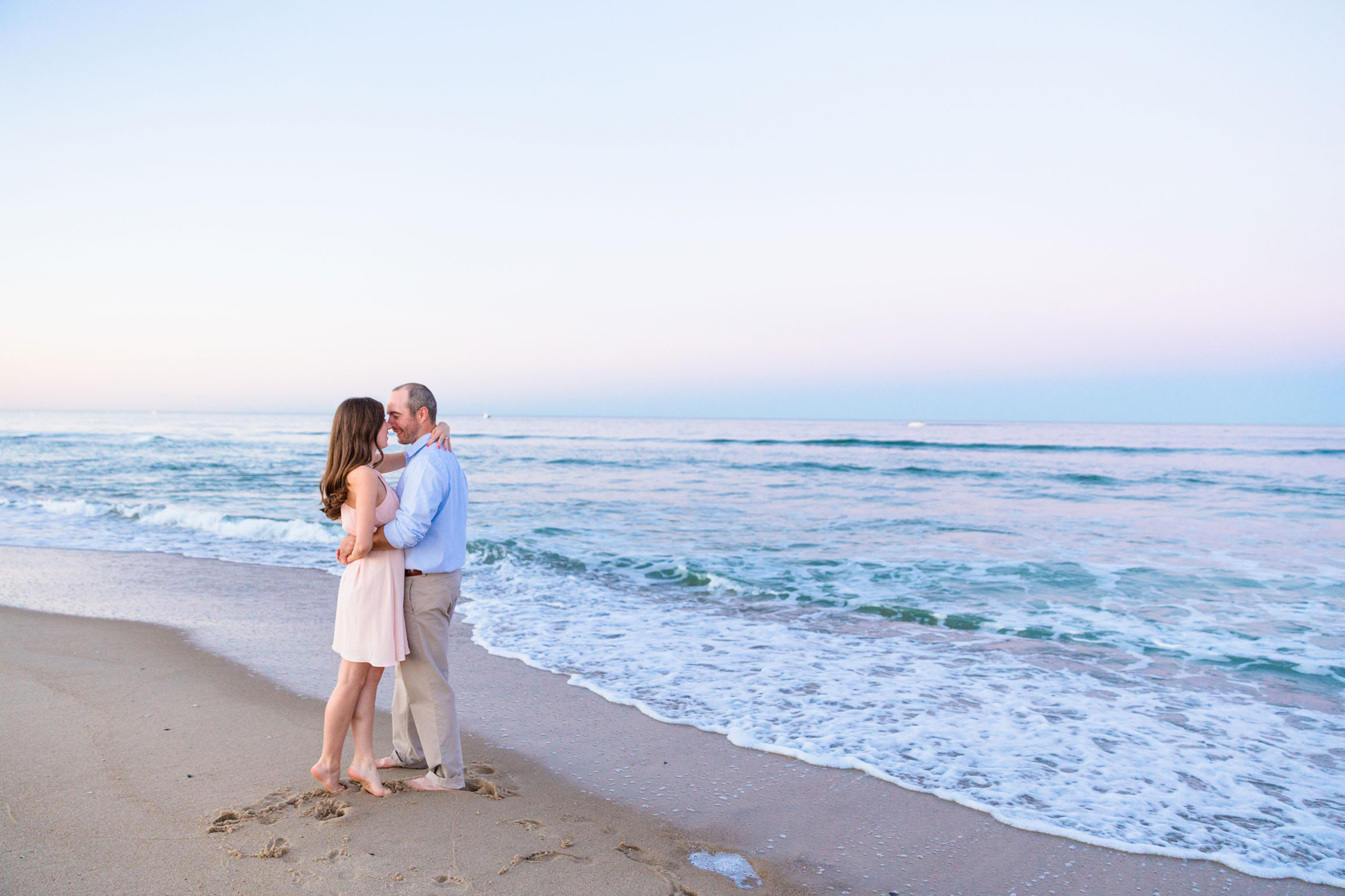 embracing on the edge of where the water meets sand