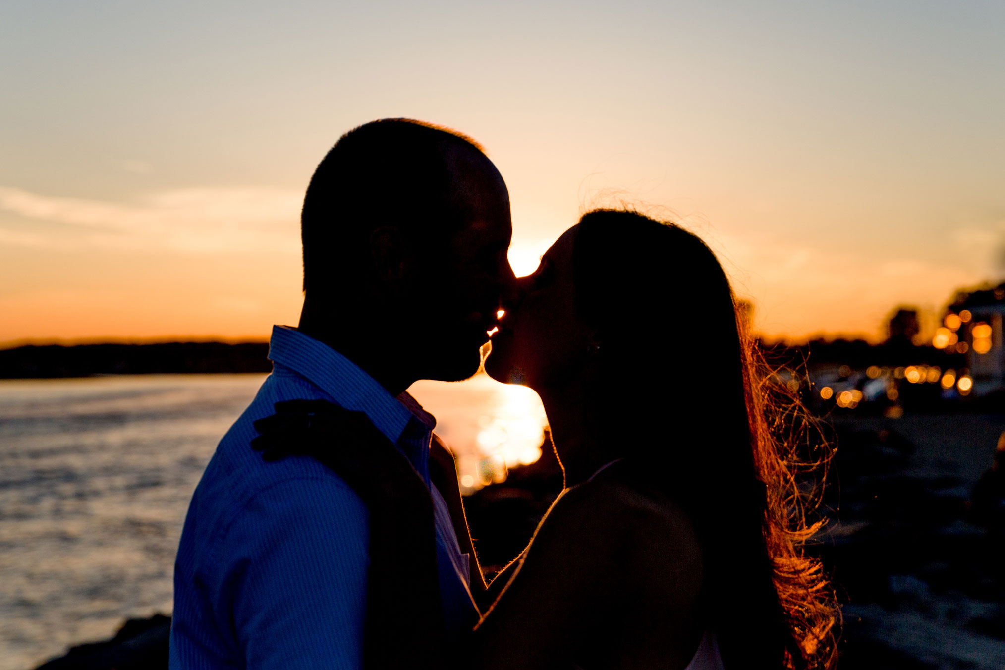 silhouette of a couple kissing at sunset