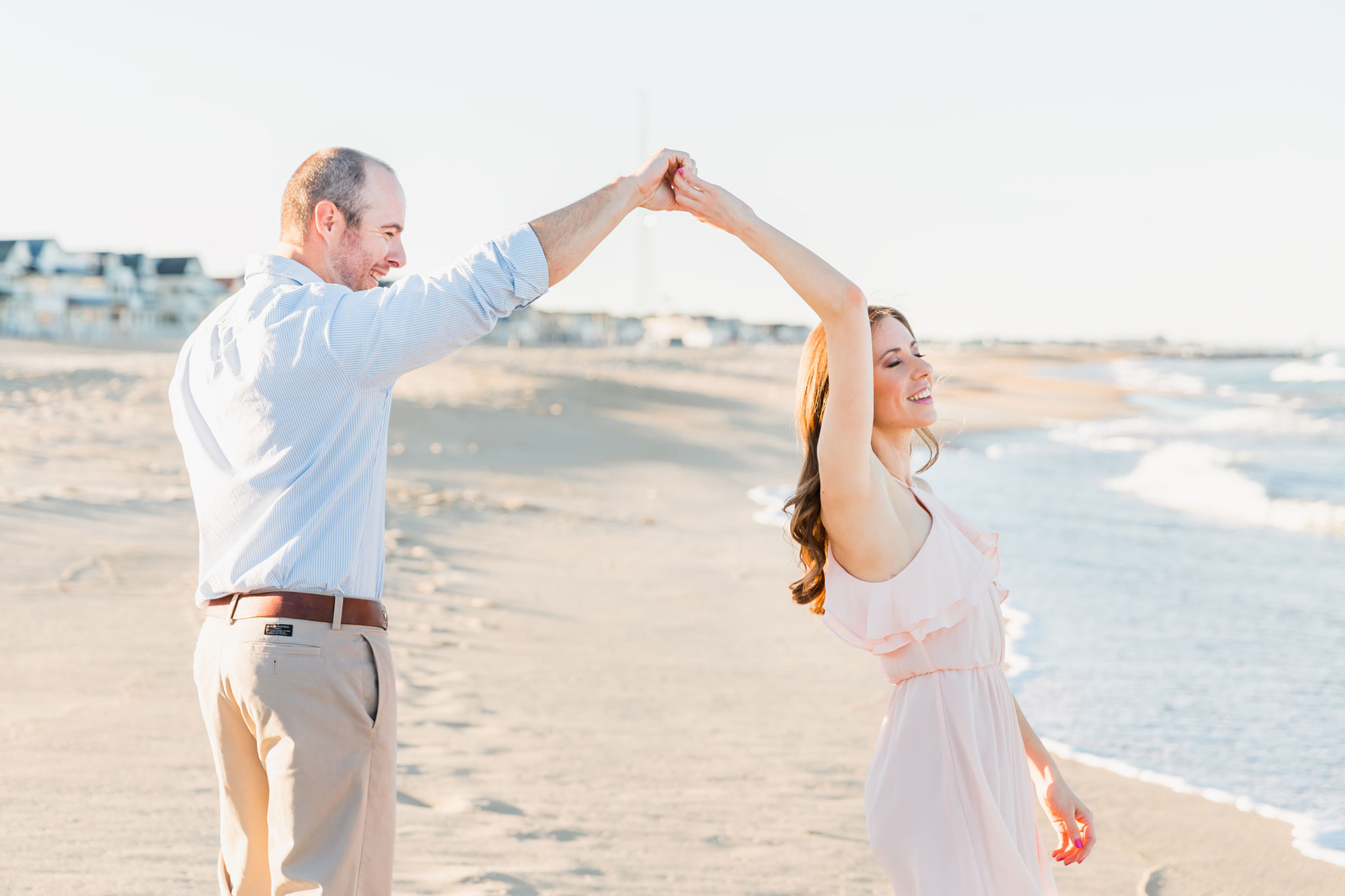 twirling his girl in the sand