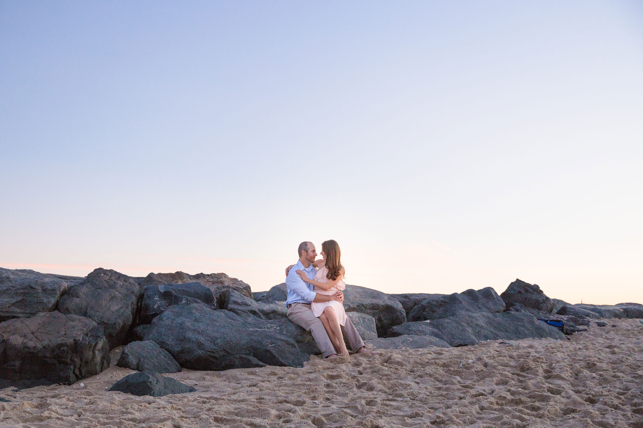 wide angle photo of couple on rock jetty